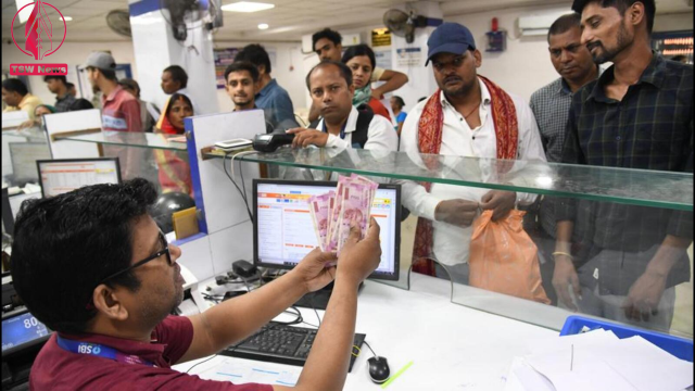 People stand in a queue to exchange ₹2,000 notes at a bank in Patna on Tuesday