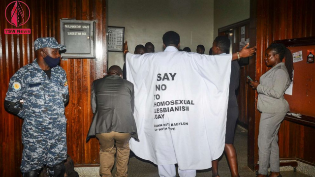 John Musila wears clothes with an anti-LGBTQ message as he enters the Parliament to vote on a harsh new anti-gay bill.